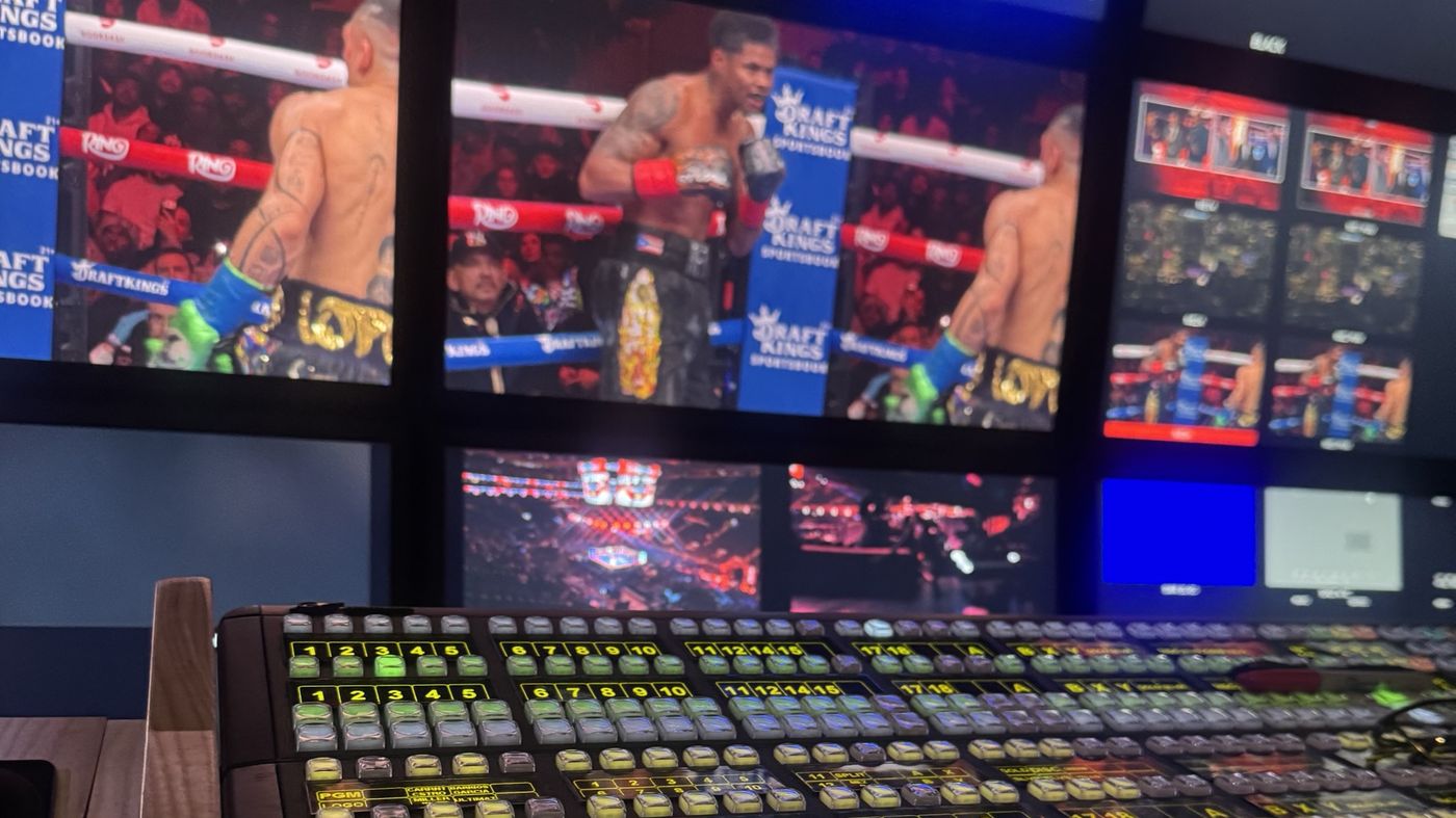 Vision mixer in the gallery with live fight feeds on the monitor wall
